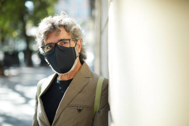 istock One senior man wearing a protective mask and looking at the camera. 1285253653