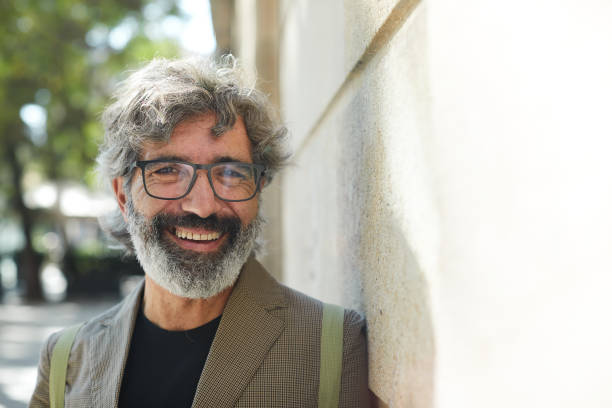 istock One middle aged man smiling at the camera on the street. 1285253678