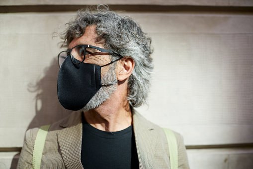 Studio Head Shots\nOne man with a protective mask looking sideways.