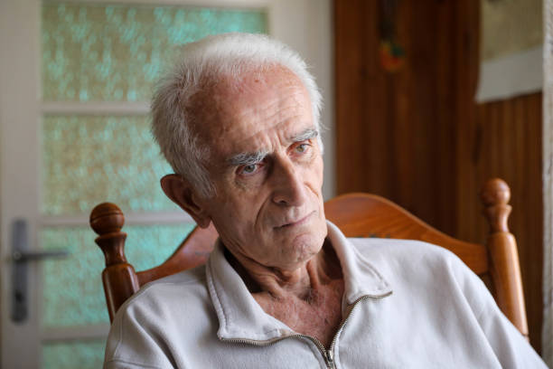 istock Old man sitting on rocking chair 1285254167