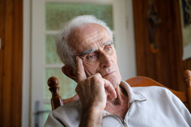 istock Old man sitting on rocking chair 1285254195