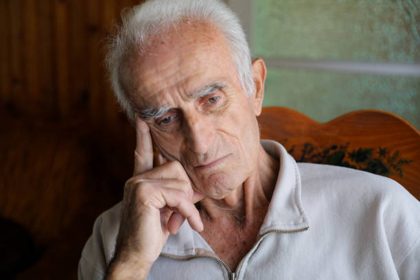 istock Old man sitting on rocking chair 1285254209
