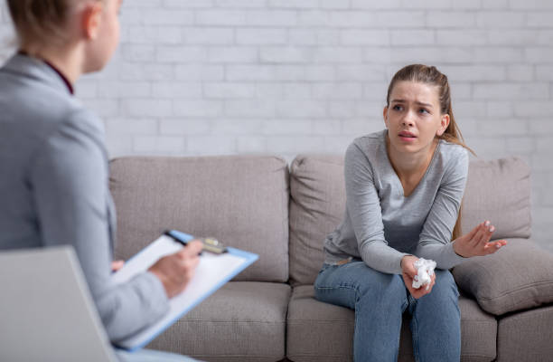 istock Psychological help service. Depressed female patient having psychotherapy session with counselor at office 1285255491