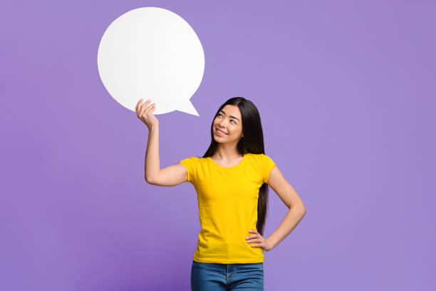 istock Nice Idea. Pensive asian woman holding and looking at blank speech bubble 1285255519