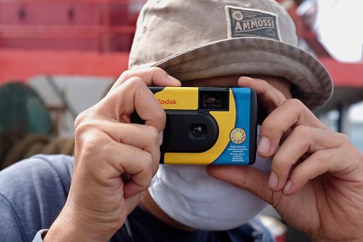 Jakarta/Indonesia - November 12, 2020: A photographer use Kodak instant camera.