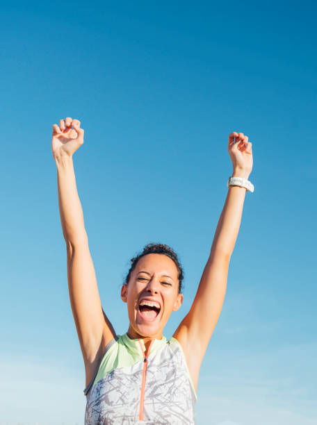 istock young female athlete raises her arms in joy 1285256812