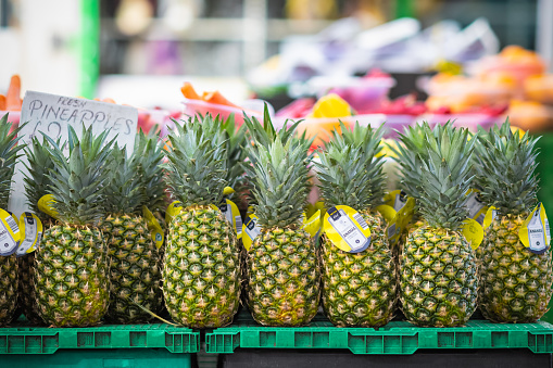 London, UK - 3 November, 2020 - Pineapples (ananas) displayed for sale at Walthamstow Market, allegedly the longest market in Europe