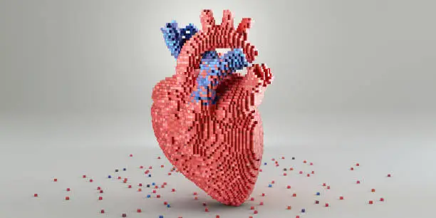 A conceptual image of a 3D model of a heart made from small multi-toned red and blue blocks. The model rests on a plain white surface, surrounded by blocks scattered at its base. A plain background with copy space.
