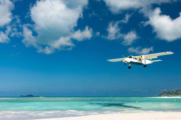 Plane landing on Nikki Beach, St. Barthelemy Plane landing on Nikki Beach, St. Barthelemy french overseas territory stock pictures, royalty-free photos & images