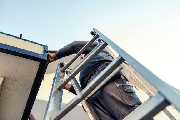 istock Worker on roof installing metal tile 1285257931