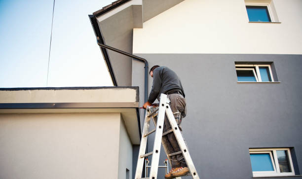 istock Manual worker on roof installing metal tile 1285257934