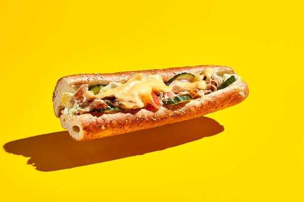 istock Flying chicken sandwich on yellow background 1285258053