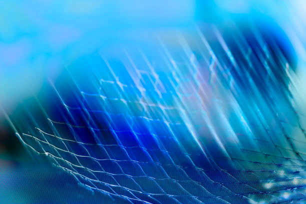 istock Artistic blue toned background with abstract net detail and light stripes 1285258321