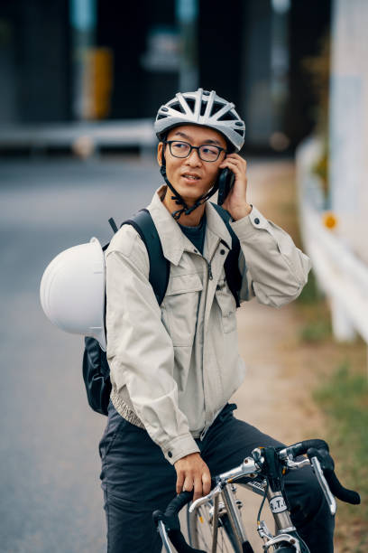 istock Mid adult man on a bicycle talking on a smart phone 1285259414