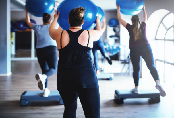 overweight women working out together in the gym - walking exercising relaxation exercise group of people imagens e fotografias de stock