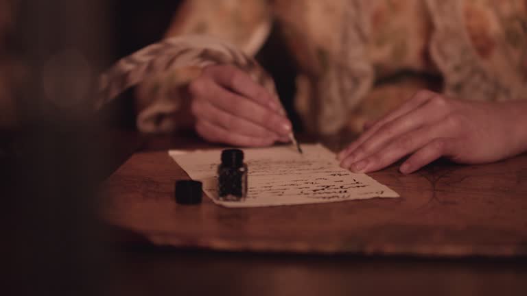 Quill and ink by candle light.