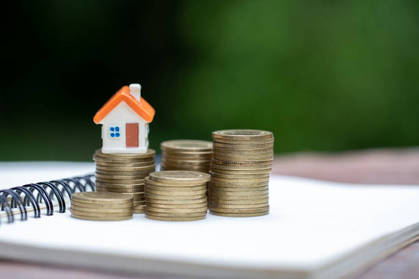 coin stacks and house model on the top, mortgage and real estate investment, for saving or investment for a house. - real estate imagens e fotografias de stock