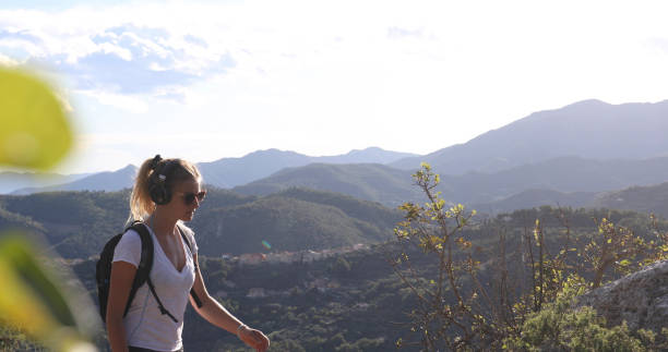 istock Young woman hikes along a mountain ridge at sunset 1285262601