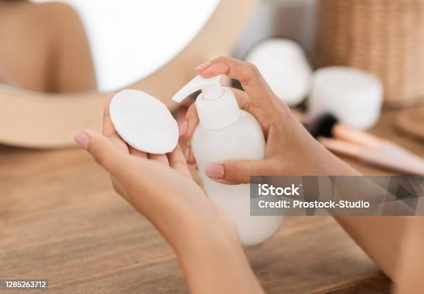 Unrecognizable Woman Applying Beauty Product On Cotton Pad Stock Photo - Download Image Now