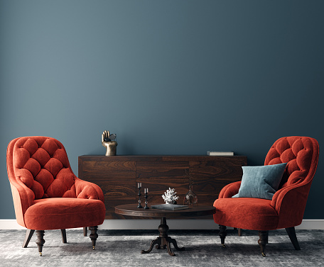 Elegant dark interior with bright red armchairs