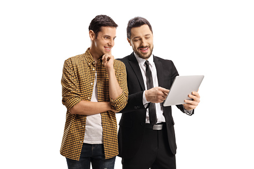 Businessman showing a tablet to a smiling young man isolated on white background