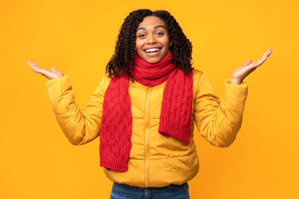 istock Black Woman Looking At Camera In Joy Over Yellow Background 1285264071
