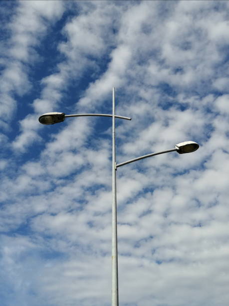 istock Two street lamps on lamppost against cloudy sky 1285264487