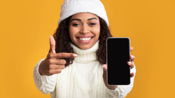istock Black woman showing blank cell phone screen 1285265271