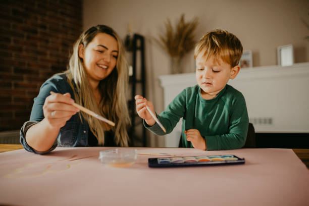 istock Mother paints with her son 1285265606