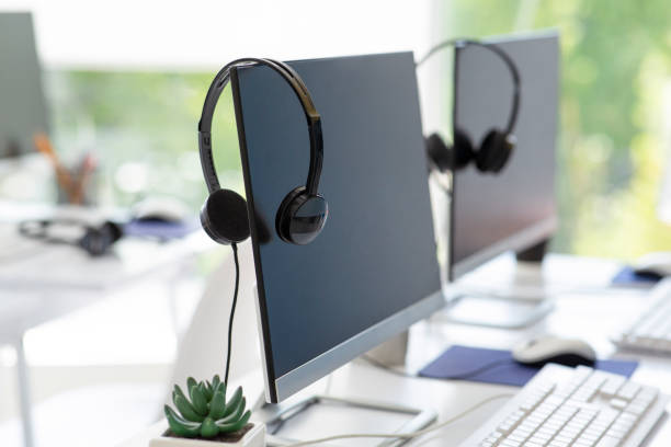 istock Computer monitor with empty space for your design and VOIP headset on desk at modern office 1285265906