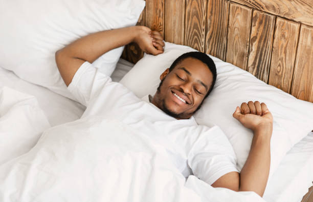 istock Cheerful Wellslept African Man Waking Up In Modern Bedroom 1285266809