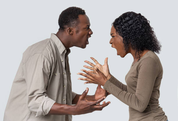 istock Angry black man and woman fighting over grey background 1285266936