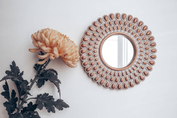 istock decorative mirror and yellow flower on a white wall. home decor 1285267628