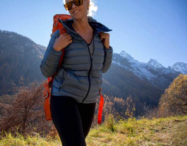 istock Female hiker walks through mountain meadow 1285268197
