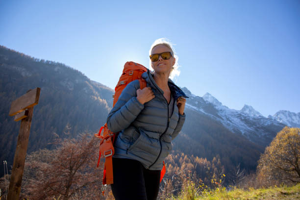 istock Female hiker walks through mountain meadow 1285268230