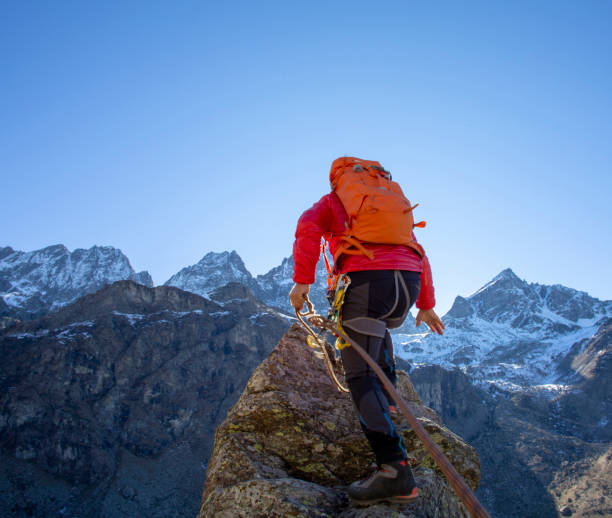 istock Mountaineer reaches summit of high pinnacle 1285268263