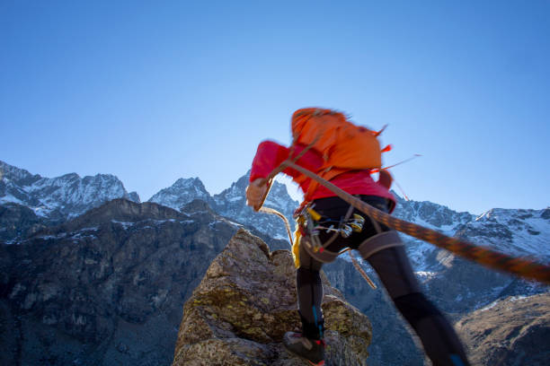 istock Mountaineer reaches summit of high pinnacle 1285268266