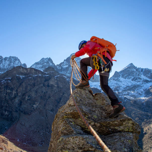 istock Mountaineer reaches summit of high pinnacle 1285268271