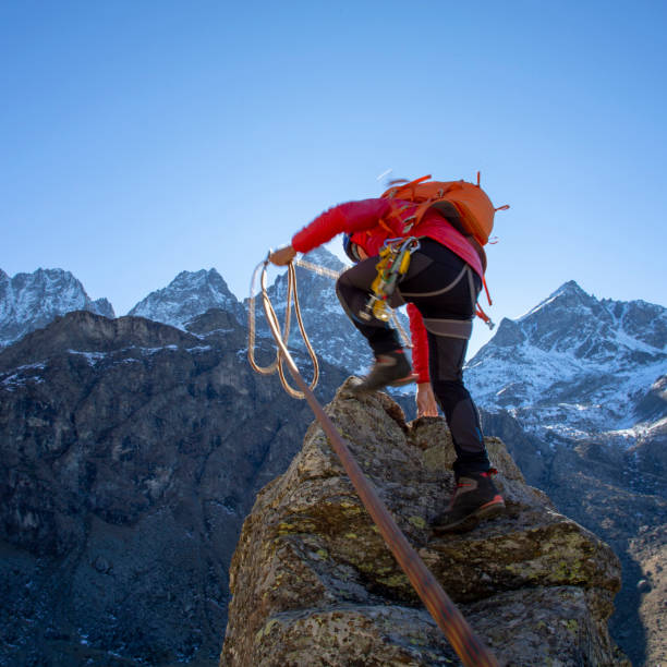 istock Mountaineer reaches summit of high pinnacle 1285268275