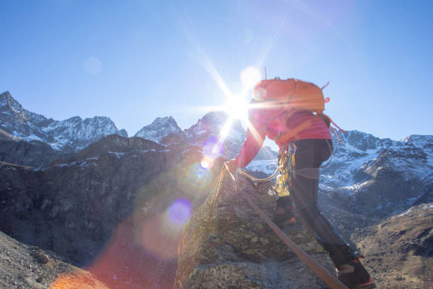 istock Mountaineer reaches summit of high pinnacle 1285268293