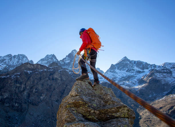istock Mountaineer reaches summit of high pinnacle 1285268323