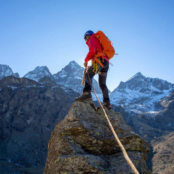 istock Mountaineer reaches summit of high pinnacle 1285268327