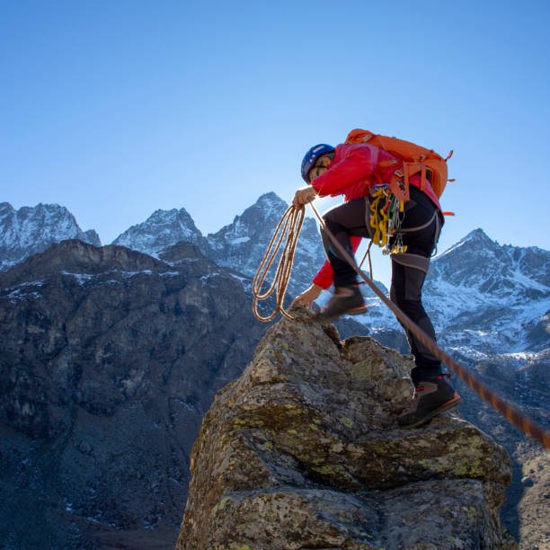 istock Mountaineer reaches summit of high pinnacle 1285268330