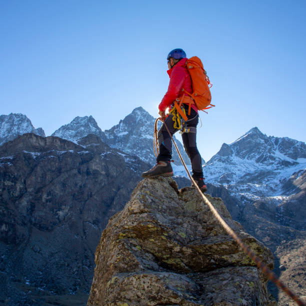 istock Mountaineer reaches summit of high pinnacle 1285268339