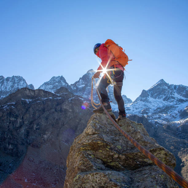 istock Mountaineer reaches summit of high pinnacle 1285268355