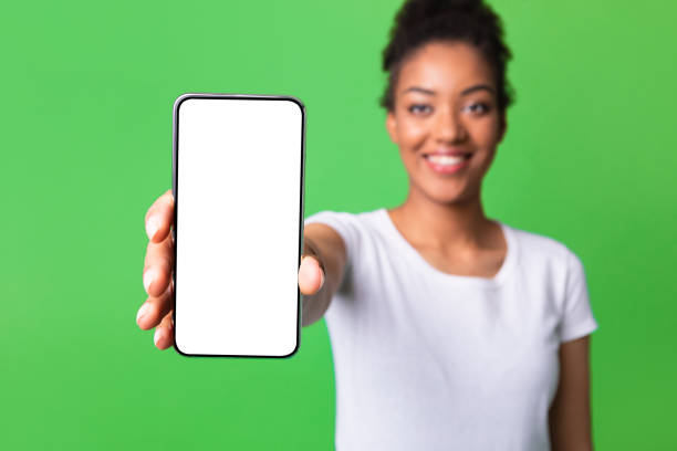 istock Black woman showing white blank cell phone screen 1285268996