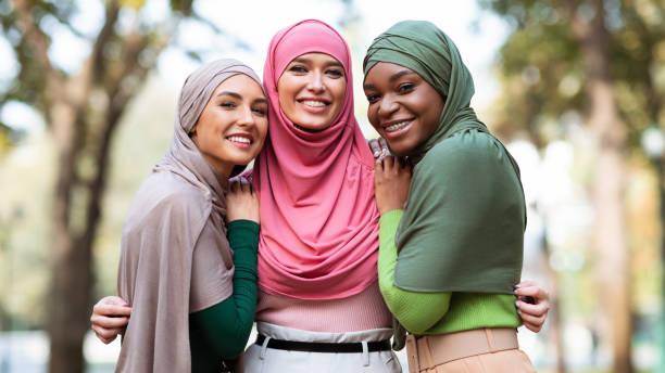 istock Three Muslim Women In Hijab Posing Hugging Outdoors, Panorama 1285270106