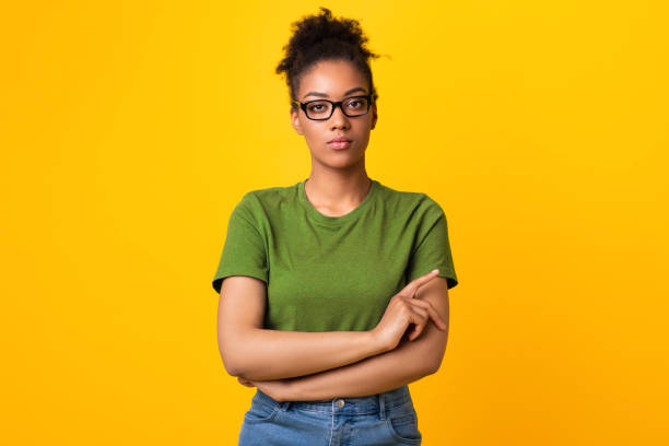 istock Confident afro woman posing on yellow background 1285270161