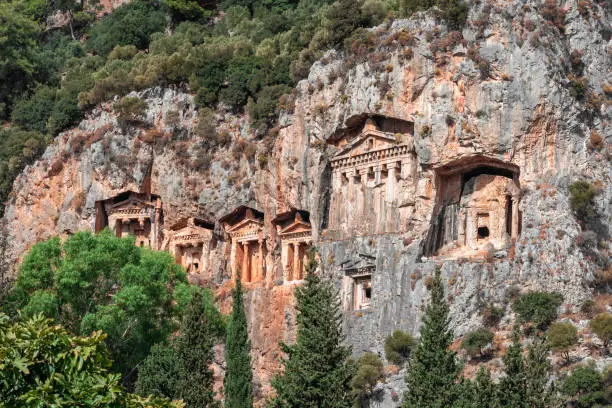 Photo of Tombs of ancient Lycian kings in the rock. Lycian tomb on a Sunny day