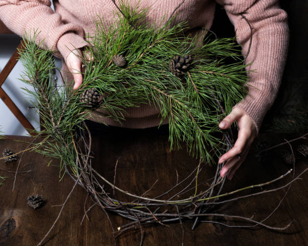 istock Woman making christmas wreath from nature branches. 1285270764